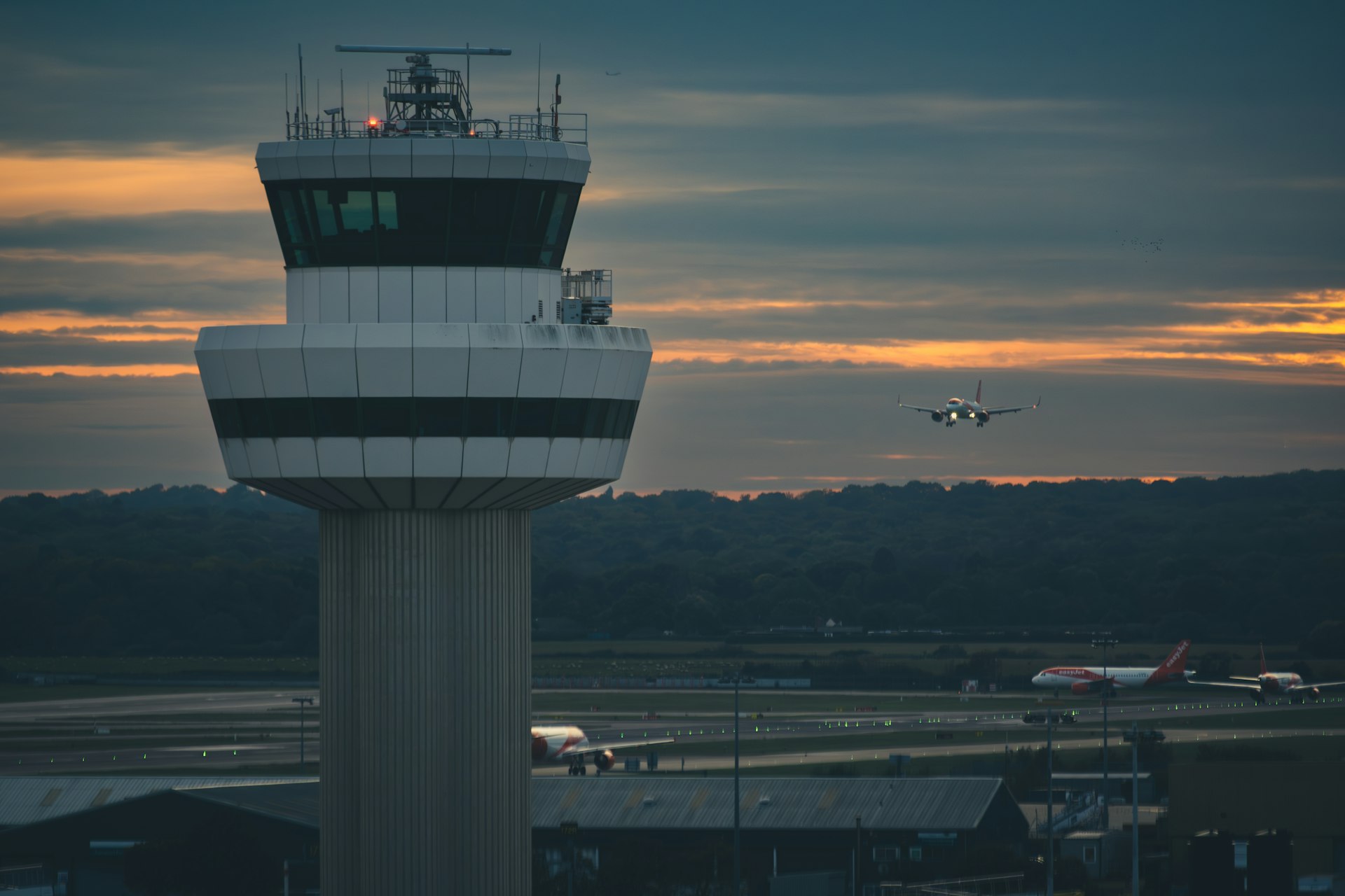 Airport control tower at night representing AI-powered travel operations live demand, real-time scheduling and workforce optimization across airports, resorts and tour operations.